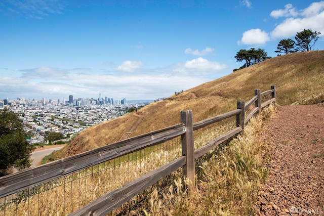 view of yard with a view of city and fence