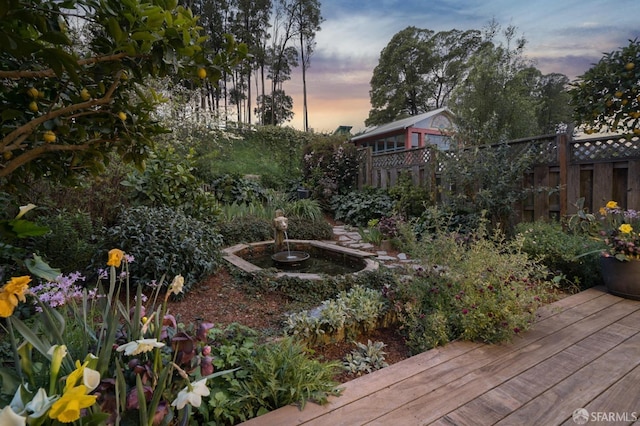 view of yard with a wooden deck and fence