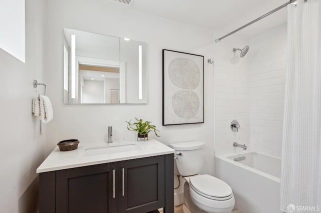 bathroom with toilet, shower / tub combo, and vanity