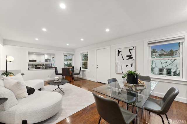 living room featuring recessed lighting, wood finished floors, and baseboards