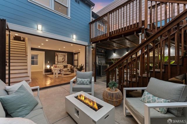 living area featuring stairway, a high ceiling, and baseboards