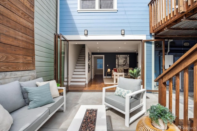 property entrance featuring outdoor lounge area and a patio