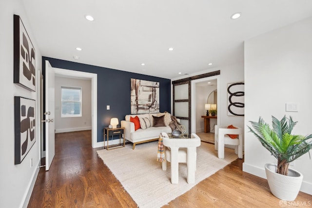 living room with wood finished floors, recessed lighting, and baseboards