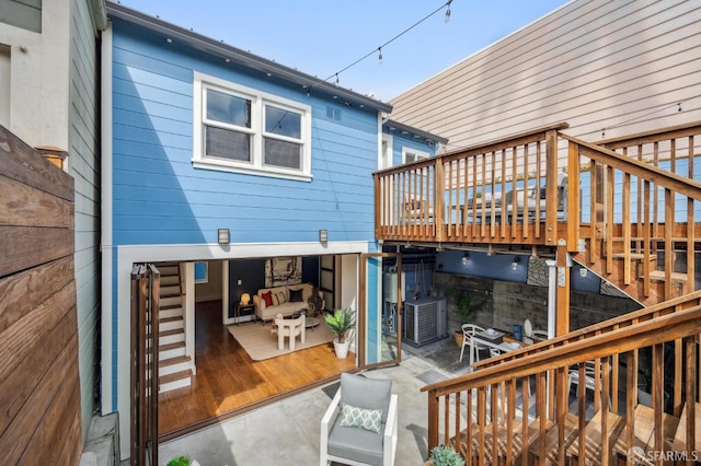 back of house with a wooden deck