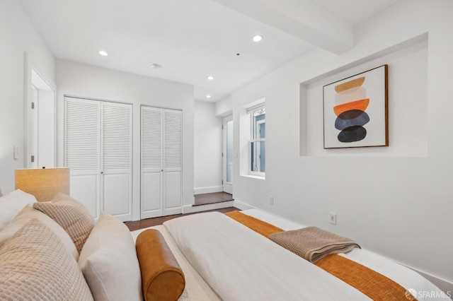 bedroom featuring recessed lighting, two closets, and baseboards