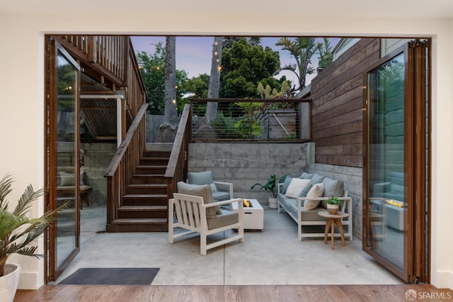 view of patio / terrace featuring stairs, fence, and an outdoor hangout area