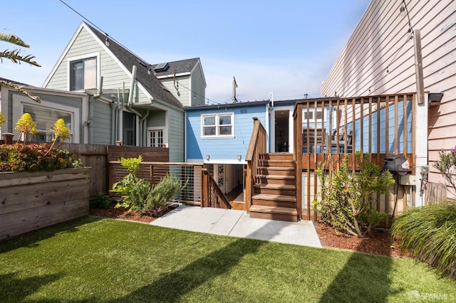 back of property featuring stairway and a deck