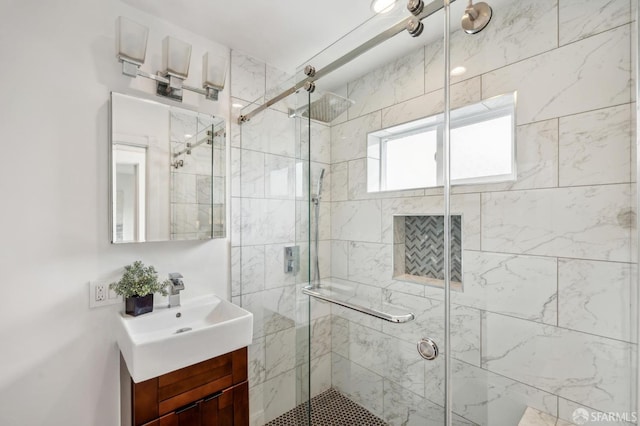 full bathroom with a stall shower and vanity