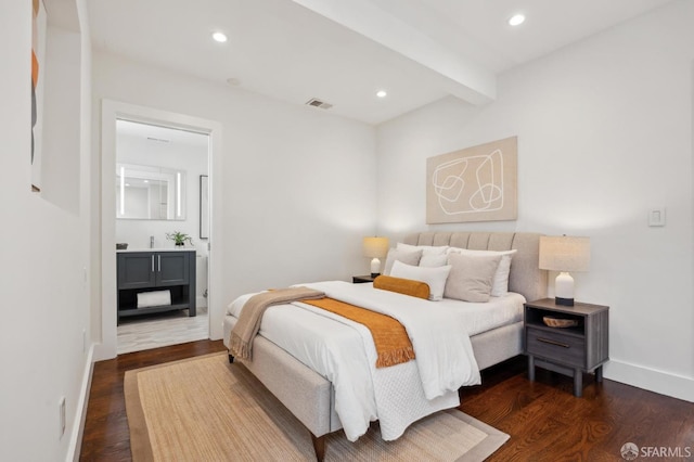 bedroom featuring dark wood-style flooring, beamed ceiling, recessed lighting, baseboards, and ensuite bathroom