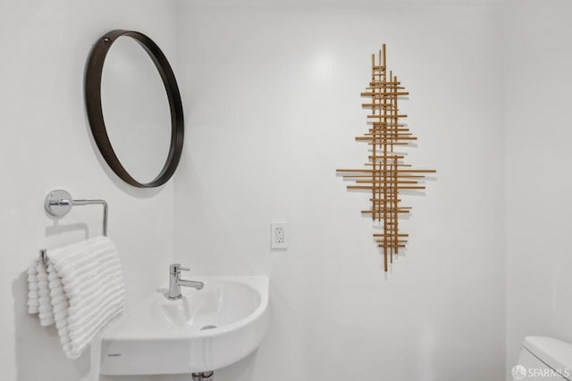 half bathroom with a sink and toilet