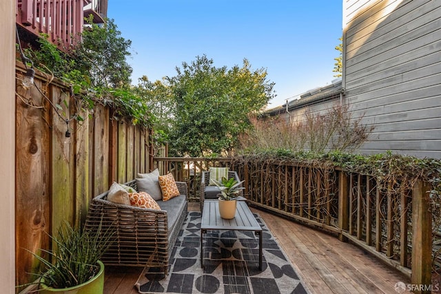 exterior space with an outdoor living space and a wooden deck