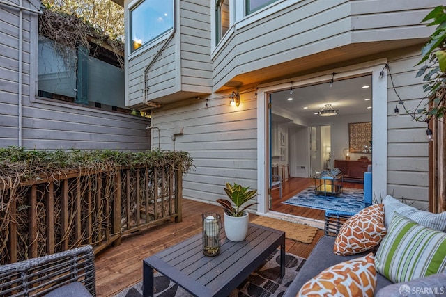 wooden terrace with an outdoor hangout area