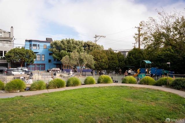 view of property's community featuring a playground and a lawn