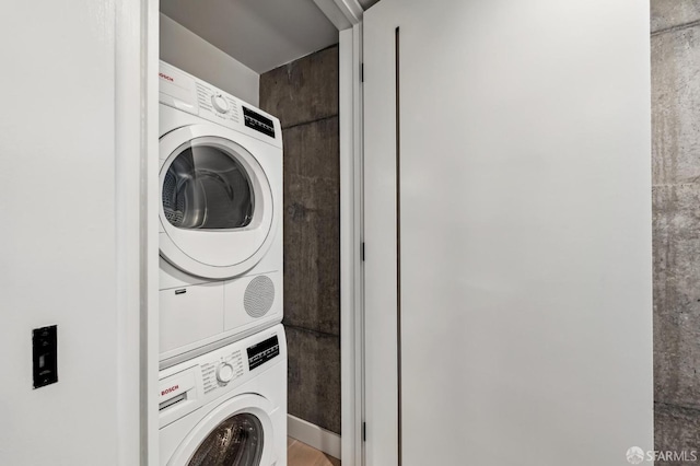 washroom featuring stacked washer / dryer