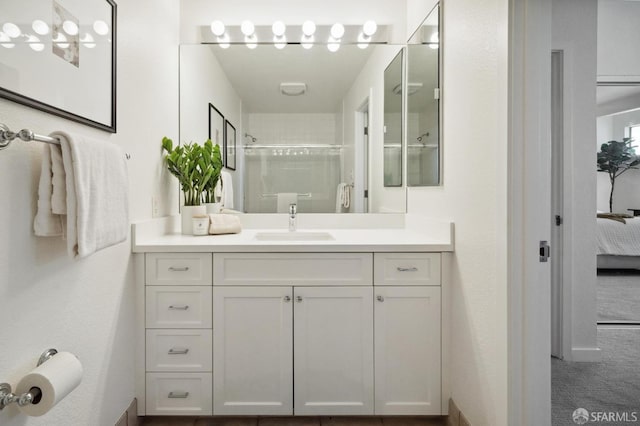 bathroom with an enclosed shower and vanity