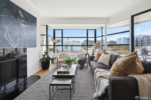 living room featuring a wealth of natural light, hardwood / wood-style flooring, and crown molding