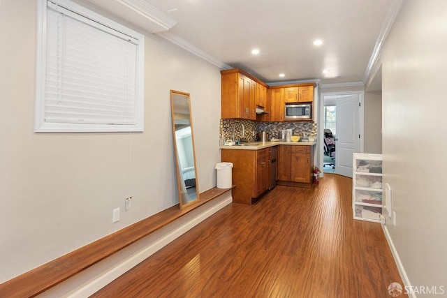 kitchen featuring decorative backsplash, dark hardwood / wood-style floors, and ornamental molding