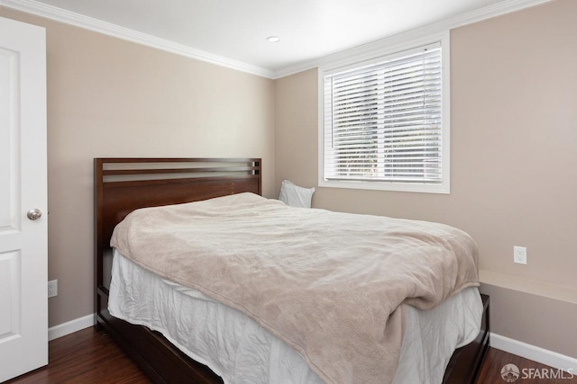 bedroom with dark hardwood / wood-style floors and ornamental molding