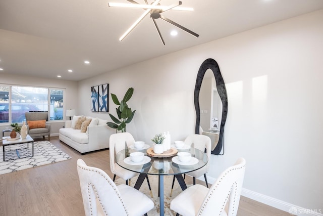 dining area featuring a notable chandelier and light hardwood / wood-style floors