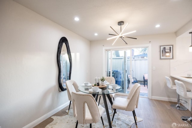 dining space featuring a chandelier and light wood-type flooring