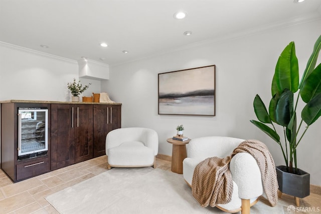 sitting room featuring recessed lighting, wine cooler, and ornamental molding