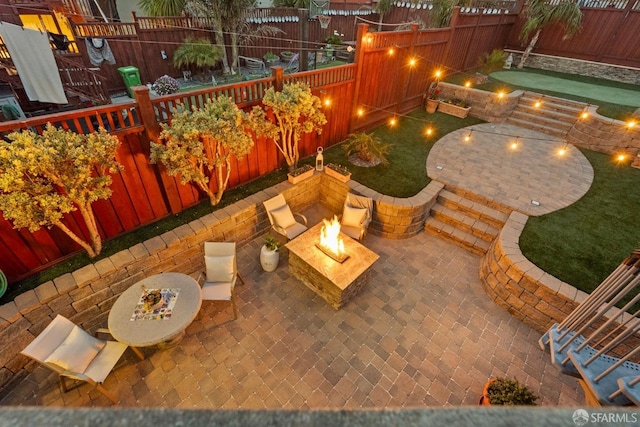 view of patio with a fire pit and a fenced backyard