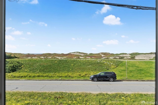 view of road with curbs and a mountain view