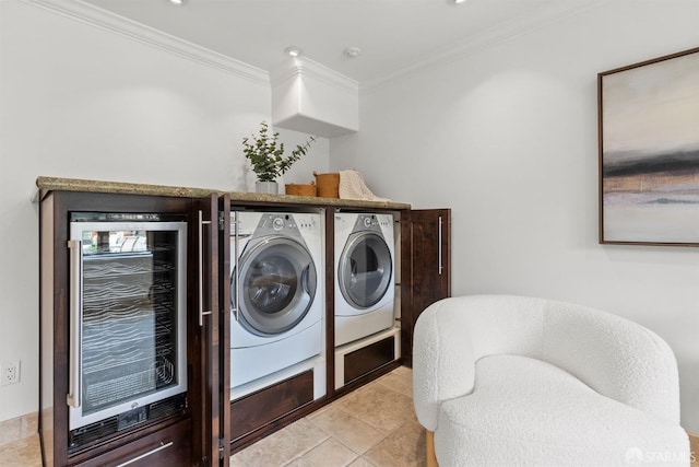 clothes washing area featuring wine cooler, ornamental molding, light tile patterned flooring, and washer and clothes dryer