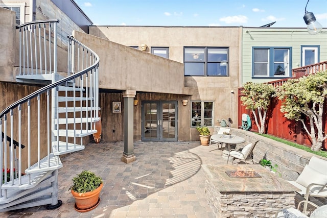 back of house with french doors, a patio, and stairway