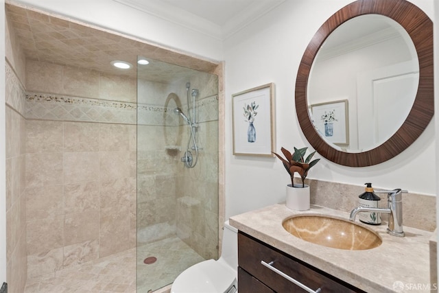 bathroom featuring vanity, crown molding, toilet, and a walk in shower