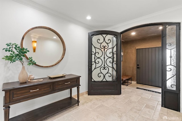 foyer entrance with crown molding and recessed lighting