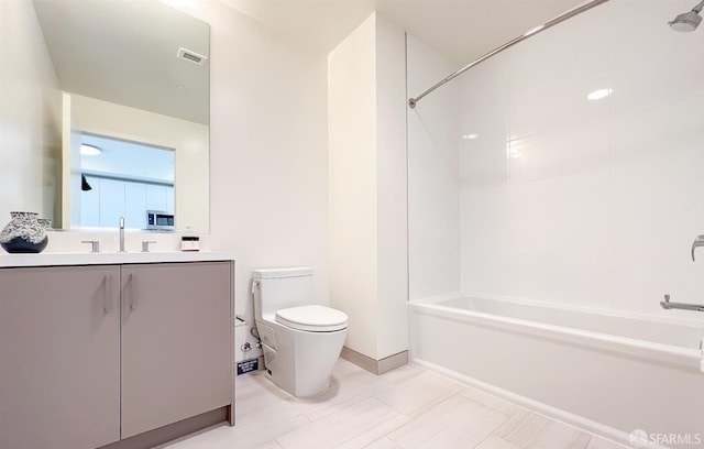 full bathroom with toilet, vanity, and tiled shower / bath