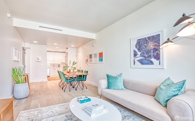 living room with light hardwood / wood-style flooring