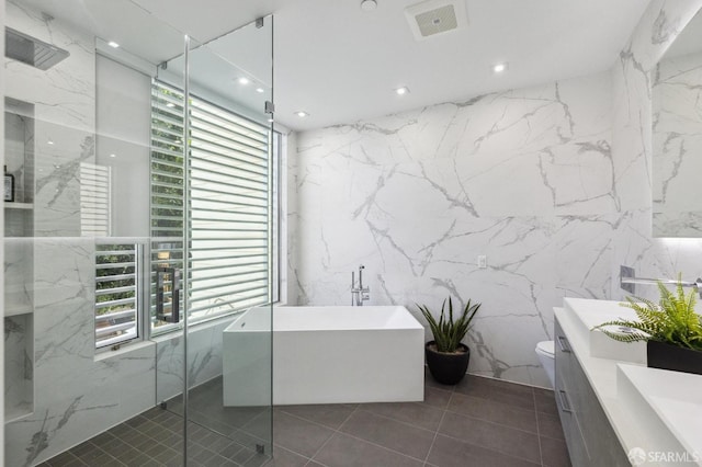 full bathroom with vanity, tile patterned floors, independent shower and bath, and toilet