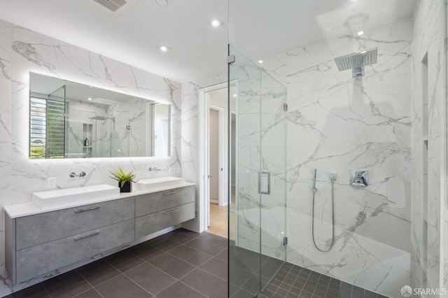 bathroom featuring vanity, tile walls, and a shower with shower door