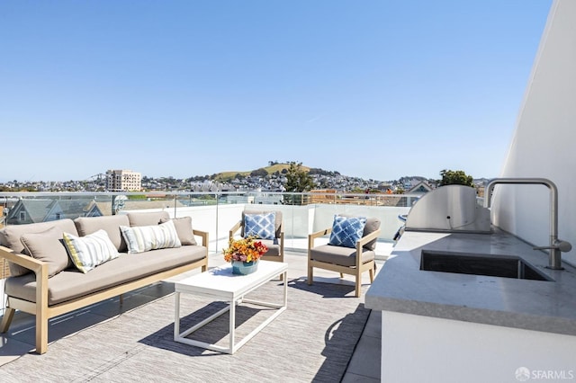 view of patio / terrace featuring an outdoor hangout area and sink