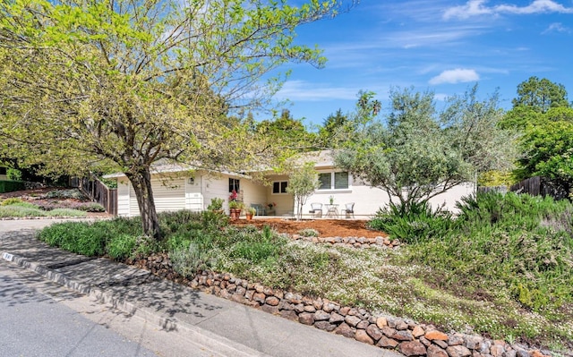 view of front of property with fence and a garage