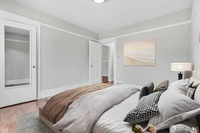 bedroom with wood-type flooring