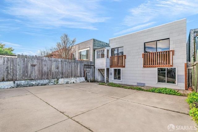 rear view of property with a balcony