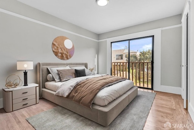 bedroom with access to outside and light hardwood / wood-style flooring