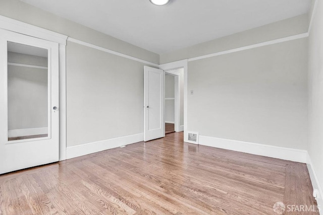 spare room with light wood-type flooring