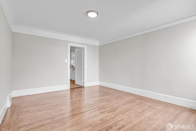 unfurnished room with ornamental molding and light hardwood / wood-style floors