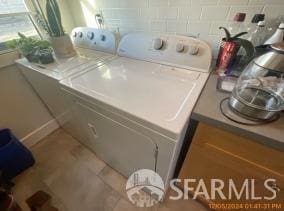 laundry room with tile patterned flooring and washer and dryer