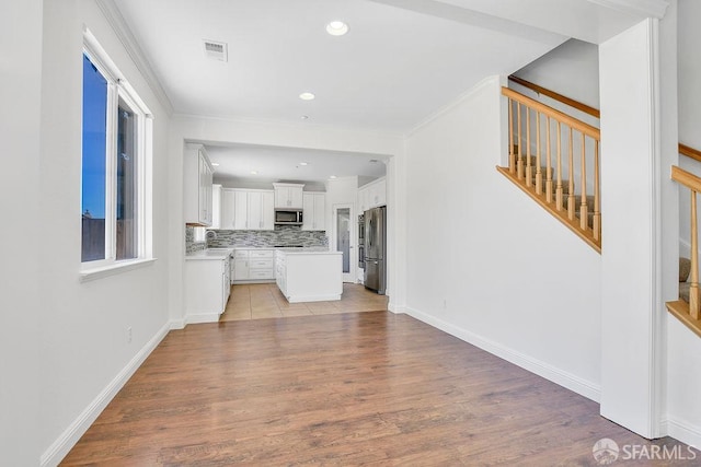 654 Tain Ct, Brentwood, CA 94513 - unfurnished living room featuring stairs, light wood-type flooring, and recessed lighting