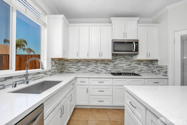 654 Tain Ct, Brentwood, CA 94513 - kitchen with appliances with stainless steel finishes, white cabinets, crown molding, and backsplash