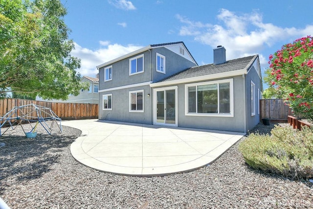 654 Tain Ct, Brentwood, CA 94513 - rear view of property featuring stucco siding, a patio, a chimney, and a fenced backyard