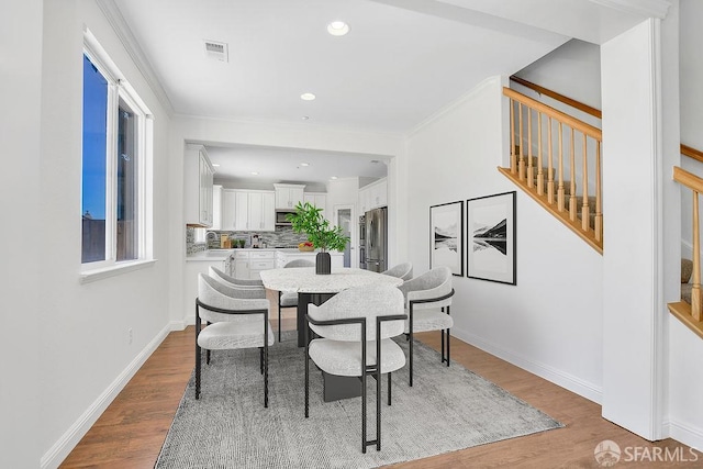 654 Tain Ct, Brentwood, CA 94513 - dining area with wood finished floors, stairs, recessed lighting, and ornamental molding