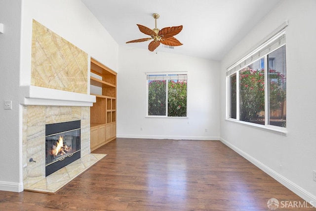 654 Tain Ct, Brentwood, CA 94513 - unfurnished living room featuring lofted ceiling, a tiled fireplace, wood finished floors, ceiling fan, and built in features