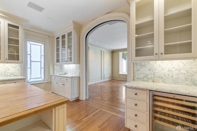 2000 Washington St Unit 4, San Francisco, CA 94109 - kitchen featuring beverage cooler, tasteful backsplash, wooden counters, glass insert cabinets, and crown molding