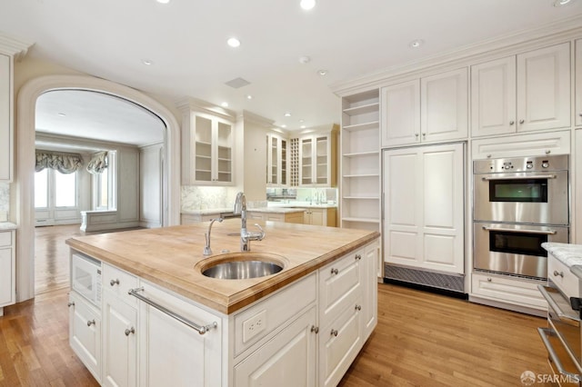 2000 Washington St Unit 4, San Francisco, CA 94109 - kitchen with a sink, butcher block counters, white microwave, stainless steel double oven, and open shelves